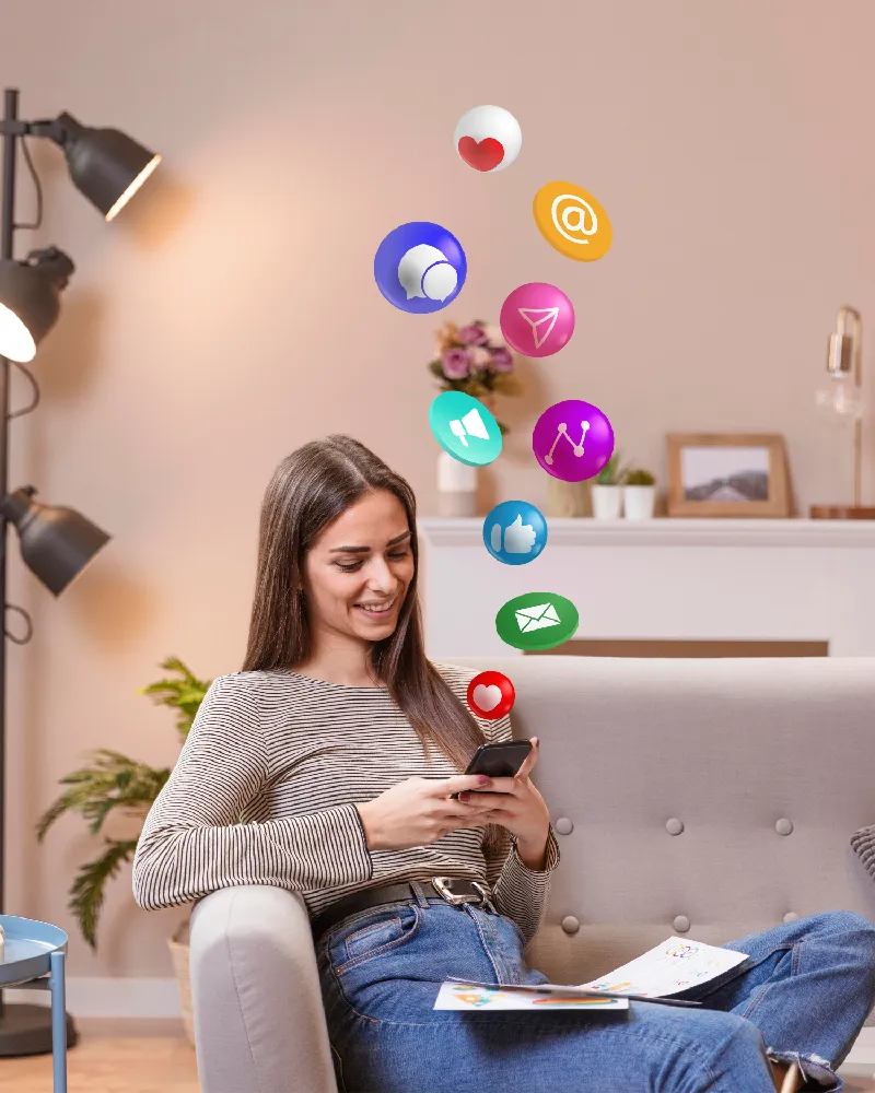 A girl sitting on a couch using mobile phone - ANA Digital Media.